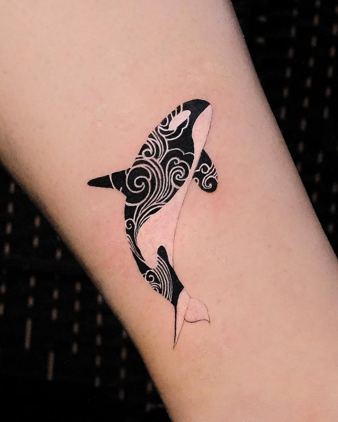 Elegant Orca Tattoo with Wave Patterns Tattoo on skin