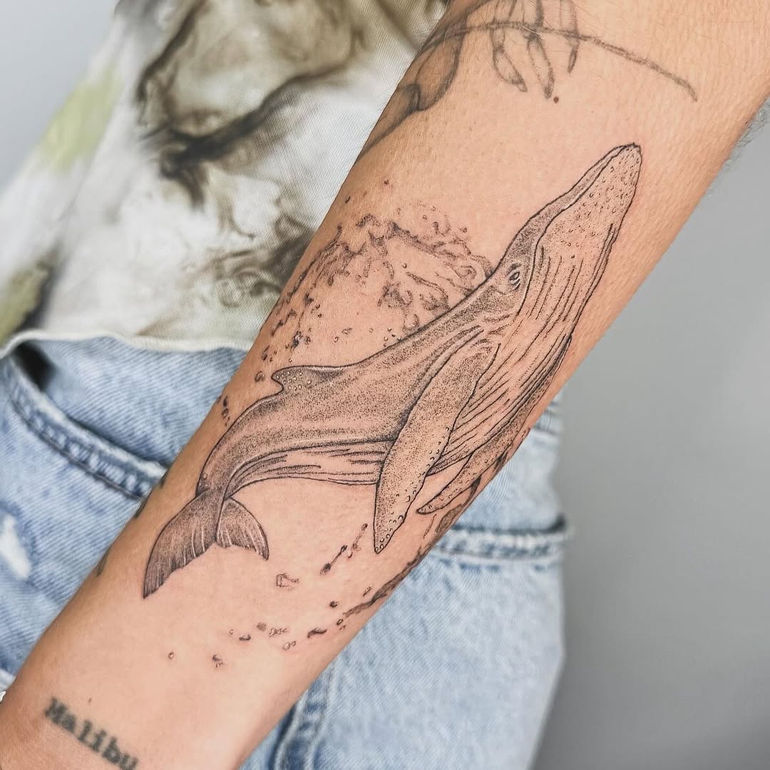 Elegant whale tattoo showcasing fine line artistry Tattoo on skin