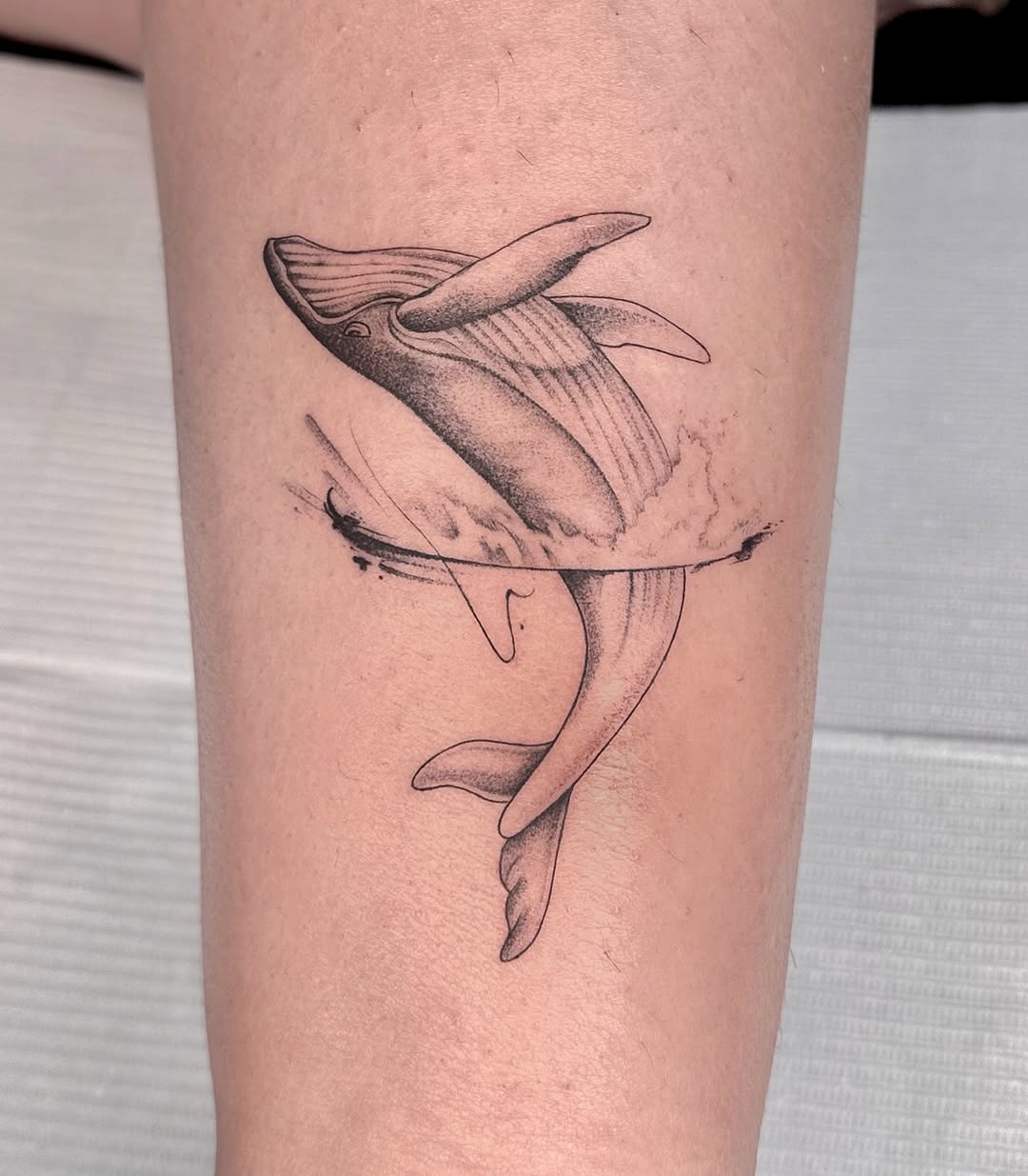 Stunning minimalist whale tattoo in motion Tattoo on skin