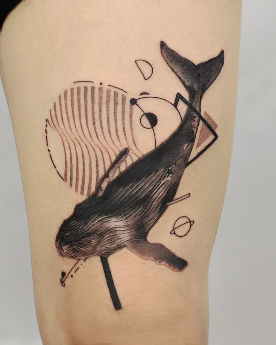 Stunning Minimalist Whale Tattoo with Abstract Elements Tattoo on skin