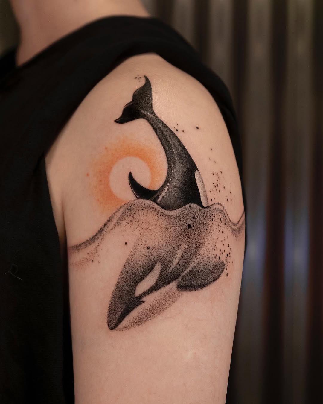 Stunning Orca Tattoo with Minimalist Waves Tattoo on skin