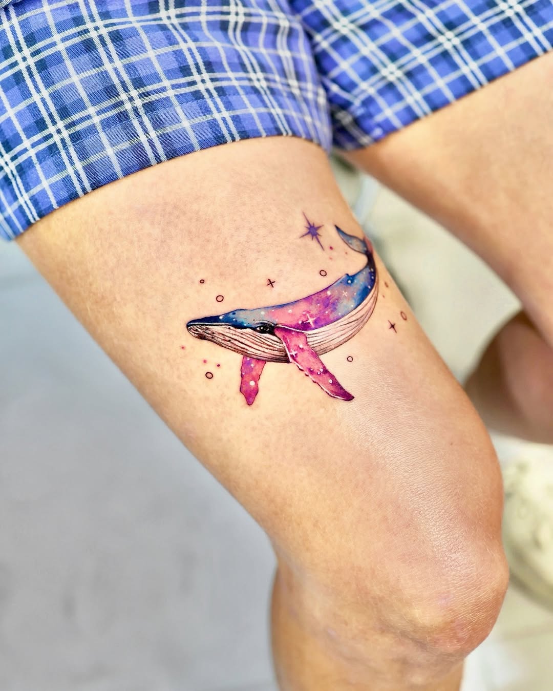 Vibrant whale tattoo with galaxy elements Tattoo on skin
