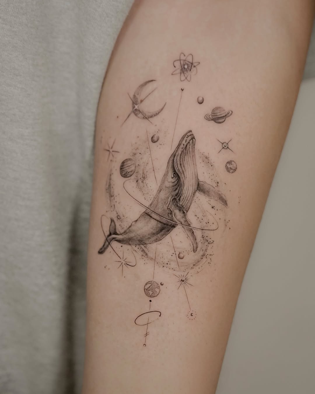 Whale tattoo with cosmic elements Tattoo on skin