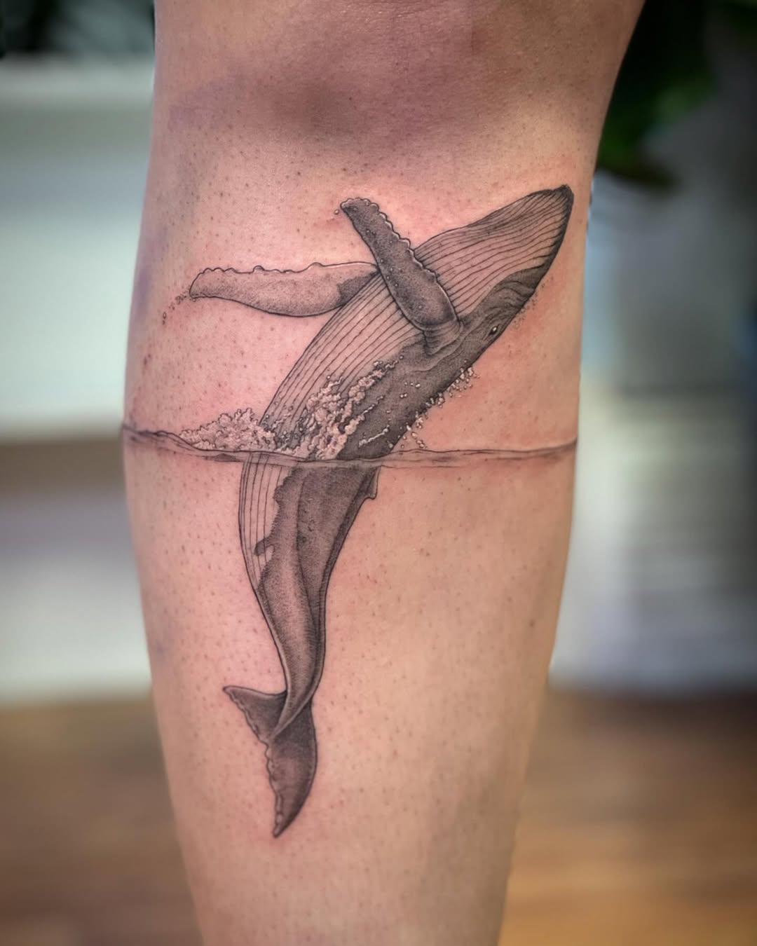 Whale tattoo with water splash detail Tattoo on skin