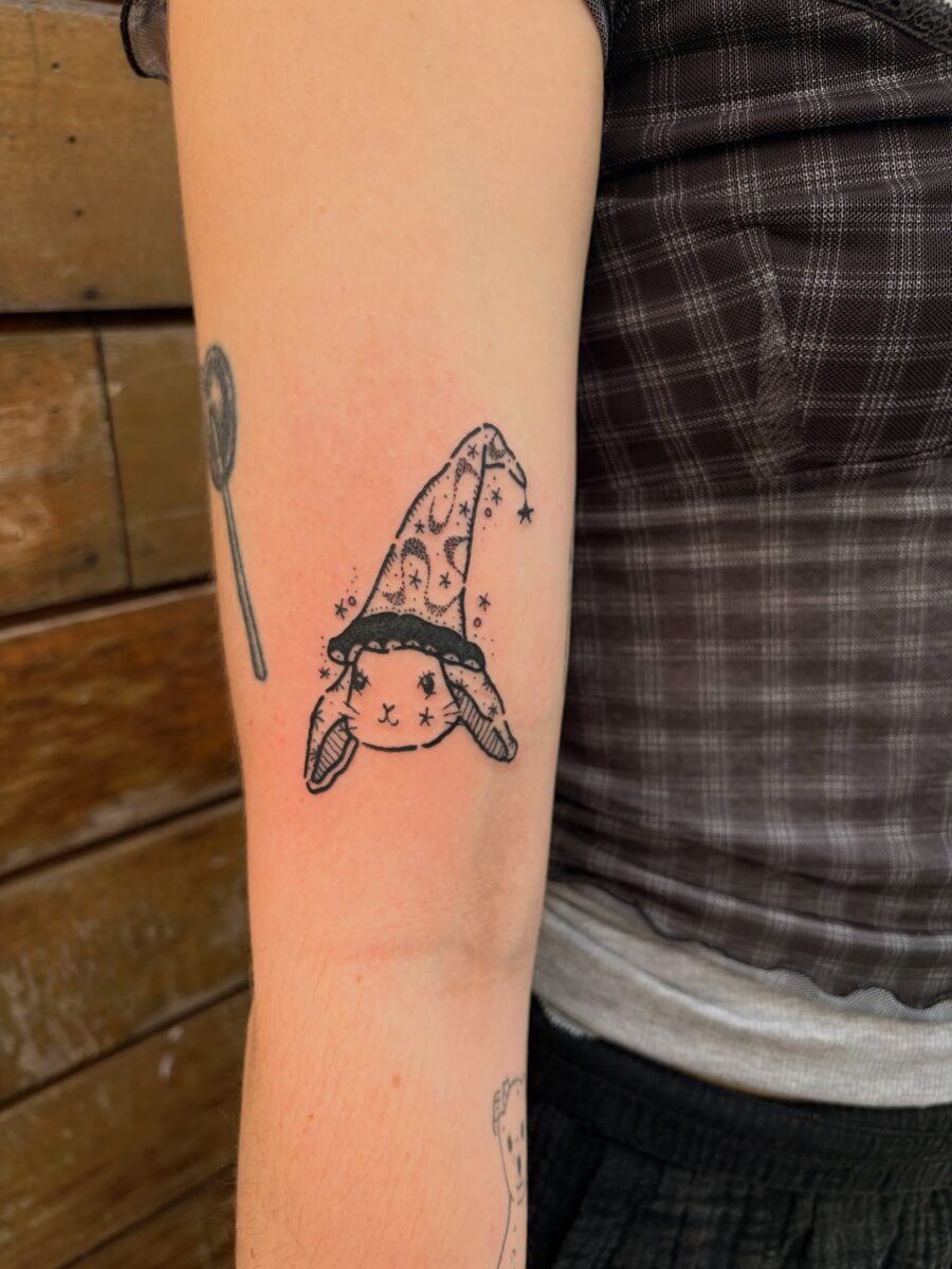 Charming bunny donning wizard hat design Tattoo on skin