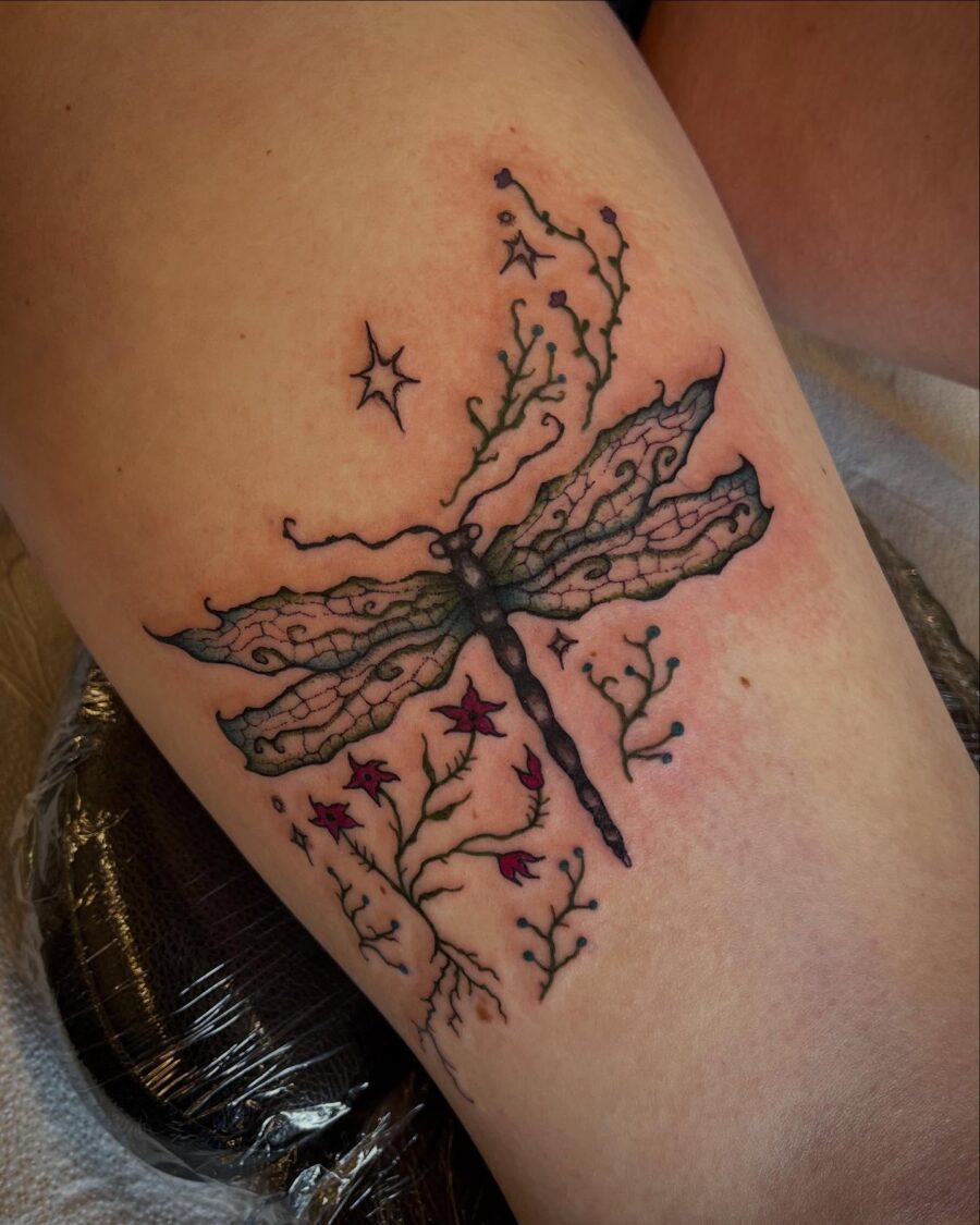 Delicate dragonfly with floral accents Tattoo on skin