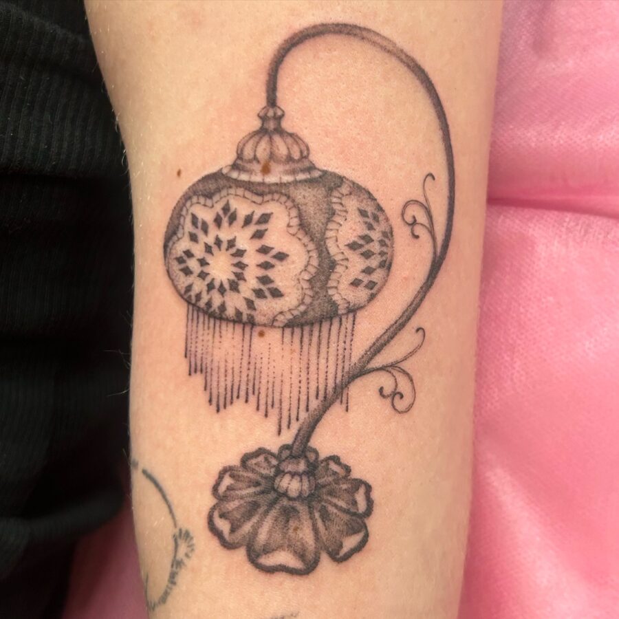 Elegant lantern tattoo with floral accents Tattoo on skin