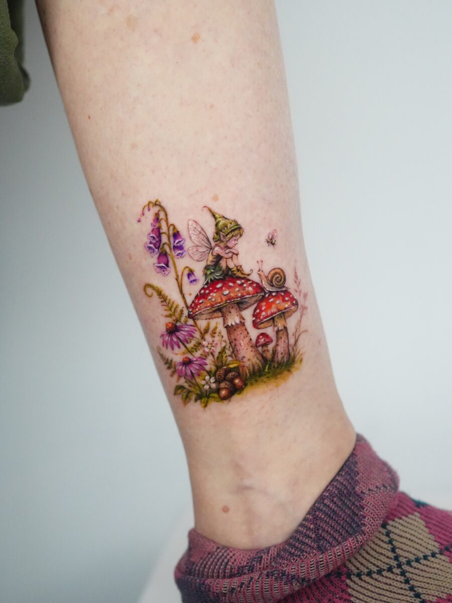 Enchanting fairy atop vibrant mushrooms and flowers Tattoo on skin