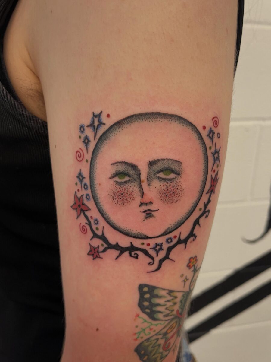 Enchanting moon face tattoo with whimsical details Tattoo on skin