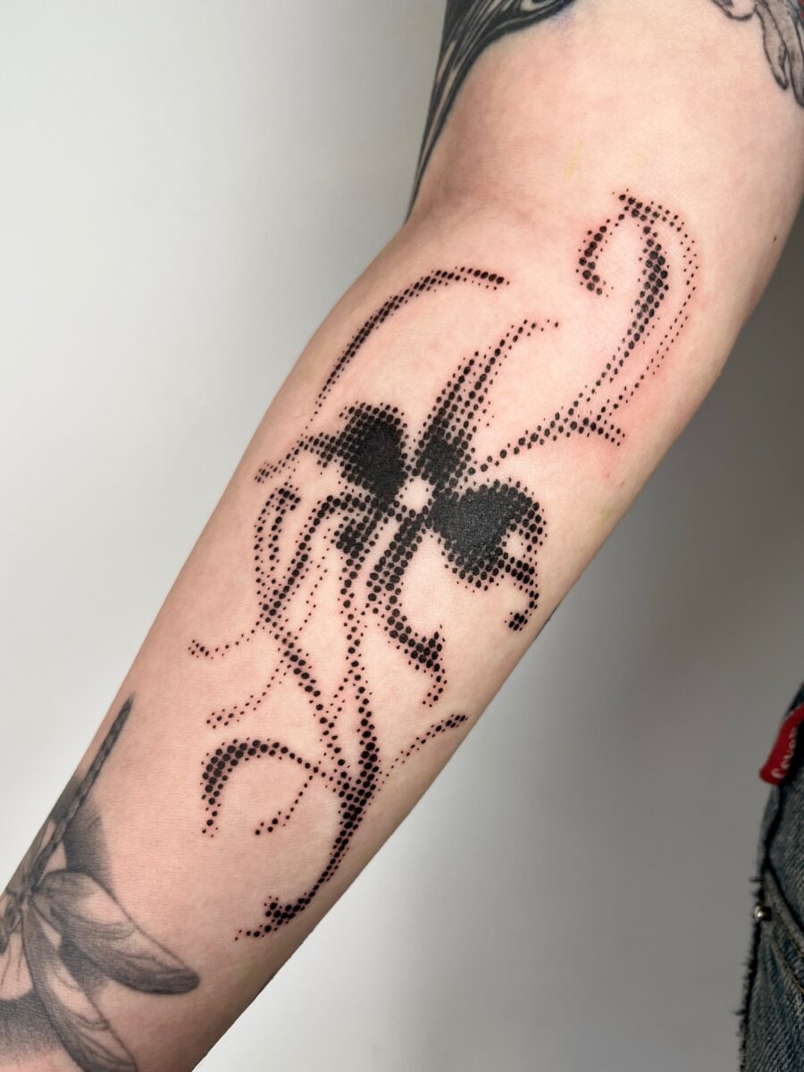 Intricate dotwork forming a whimsical floral design Tattoo on skin