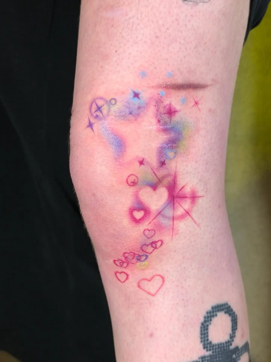Playful hearts and vibrant sparkles unite here Tattoo on skin