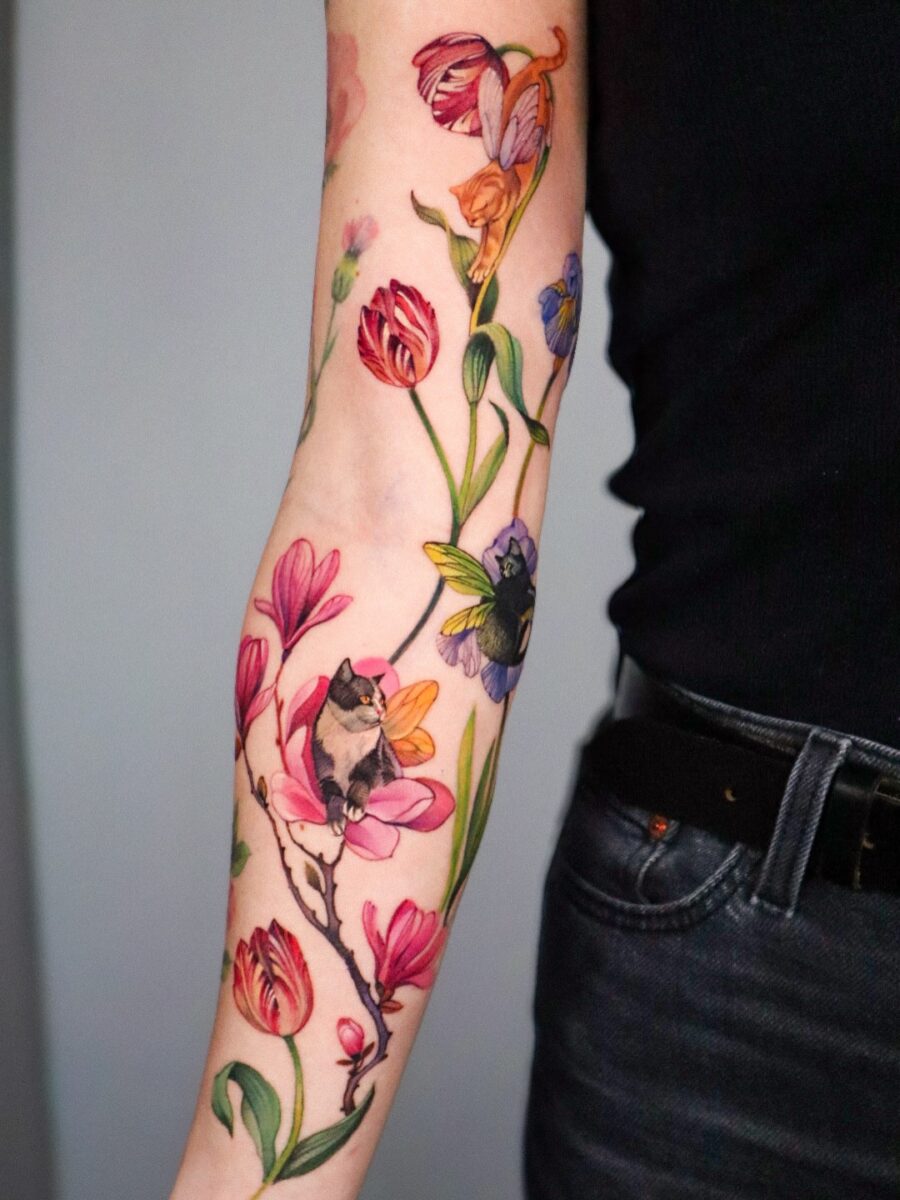 Vibrant floral tattoo with enchanting bird elements Tattoo on skin