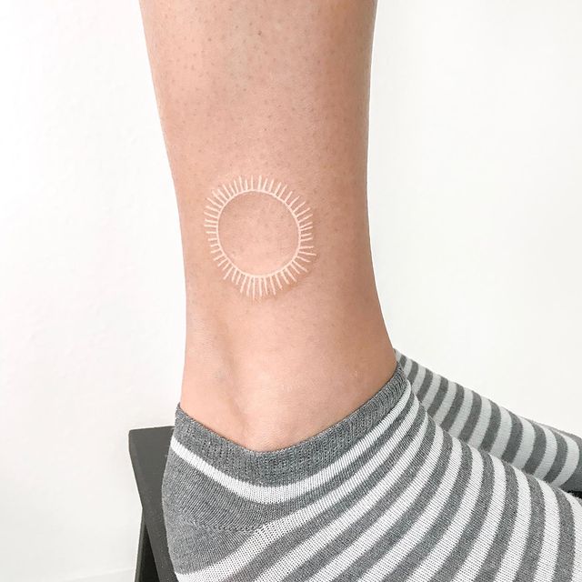 Embracing the Light From the Sun White Ink Tattoo Tattoo on skin