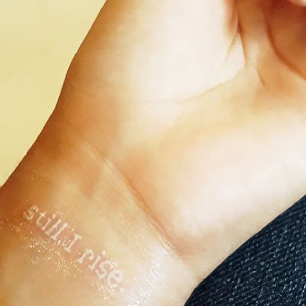 Juxtaposition of Word vs. Contrast White Ink Tattoo Tattoo on skin