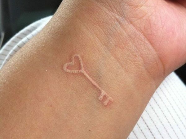The Key to Unlocking the Heart White Ink Tattoo Tattoo on skin