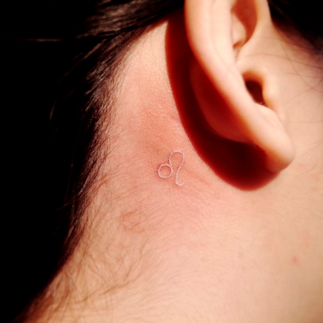 Understated Expression of Zodiac White Ink Tattoo Tattoo on skin