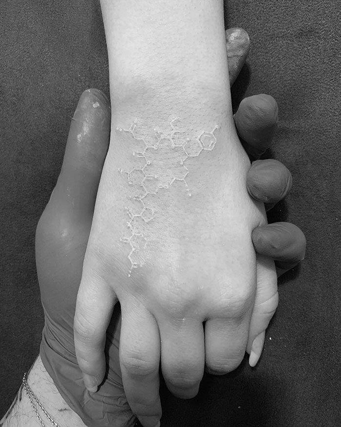 Whole Is Greater Than the Sum of Its Parts White Ink Tattoo Tattoo on skin