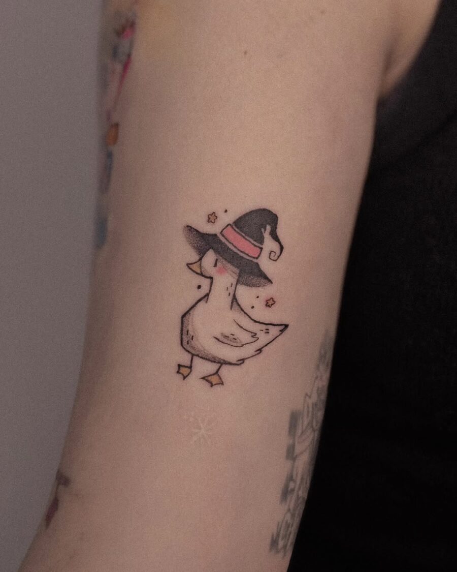 Adorable duck sporting a witch hat tattoo Tattoo on skin