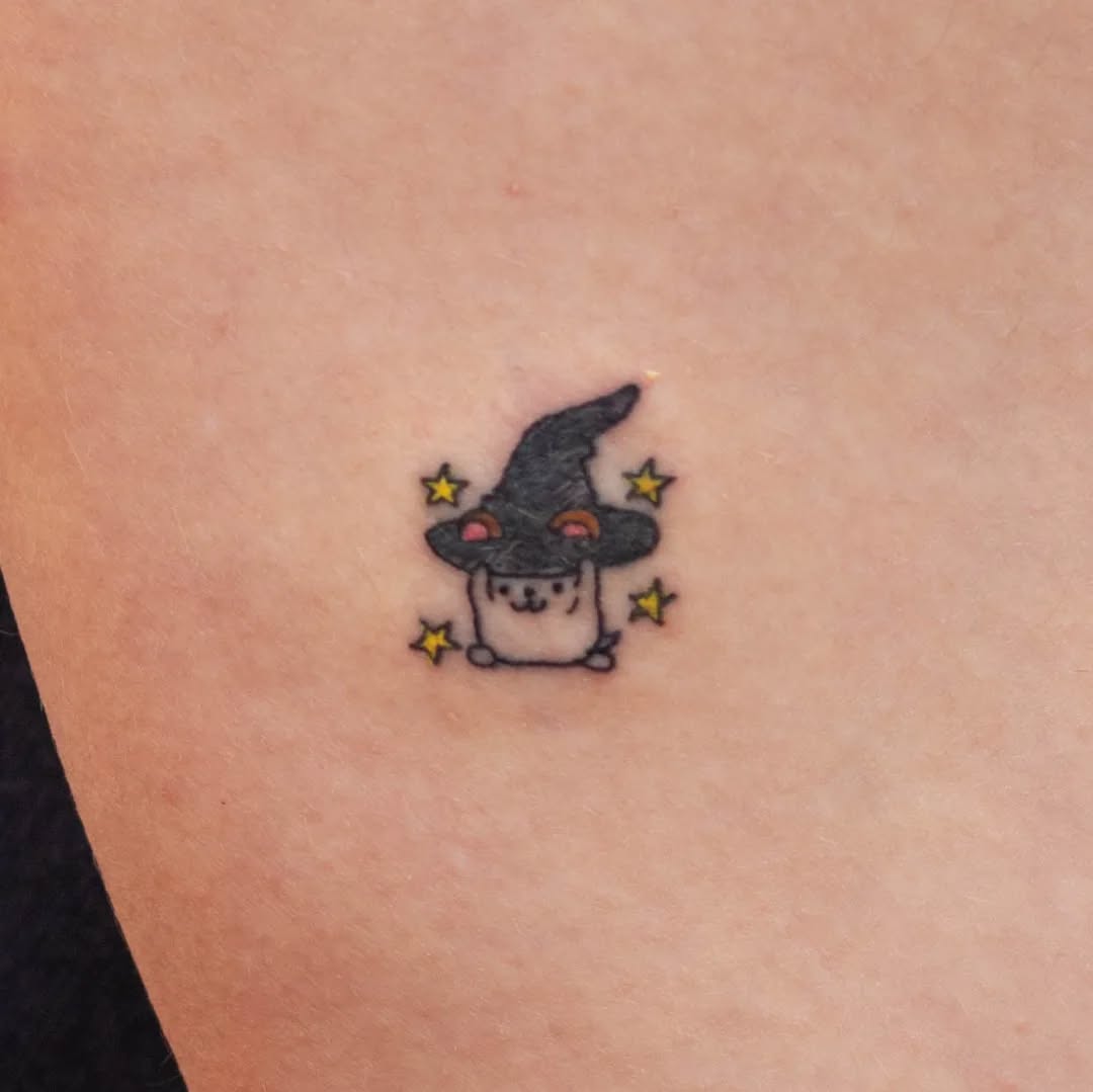 Adorable hamster in a witch hat tattoo Tattoo on skin