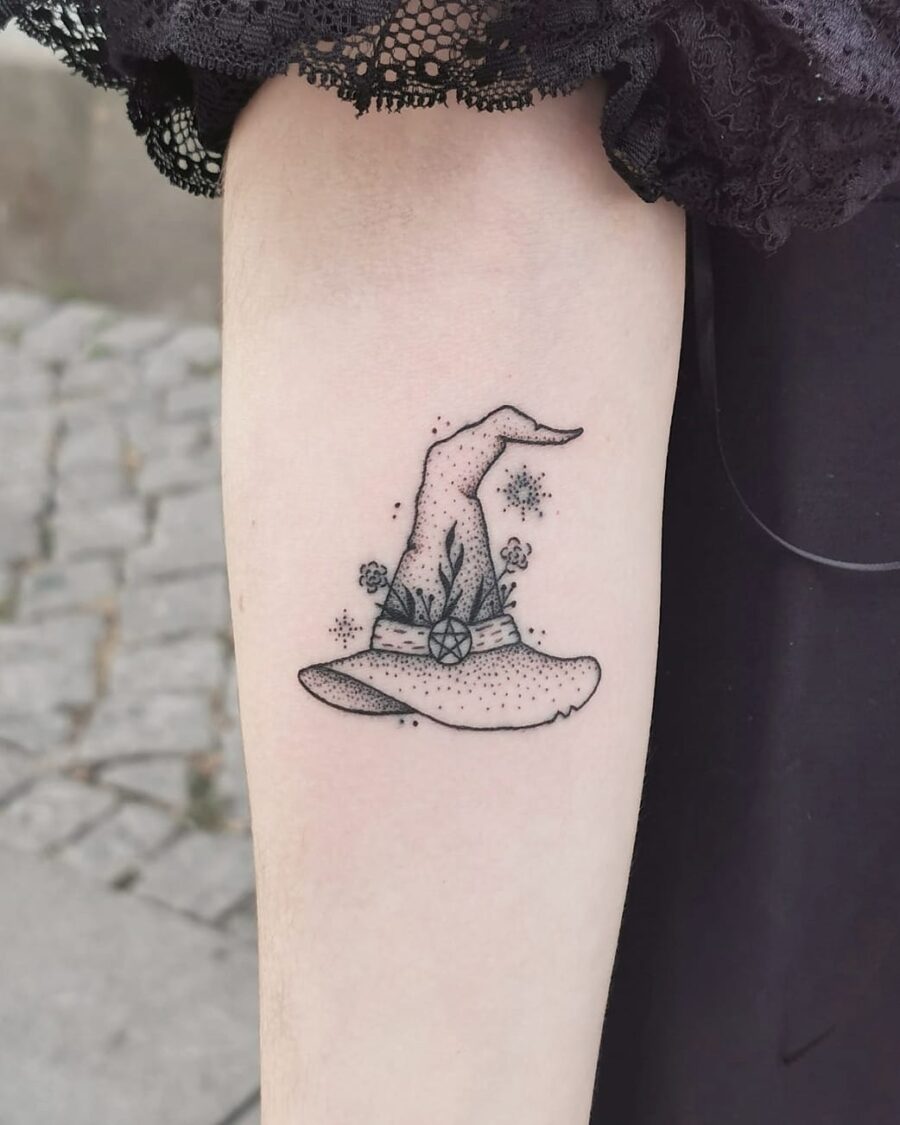 Charming floral witch hat tattoo with a whimsical touch Tattoo on skin