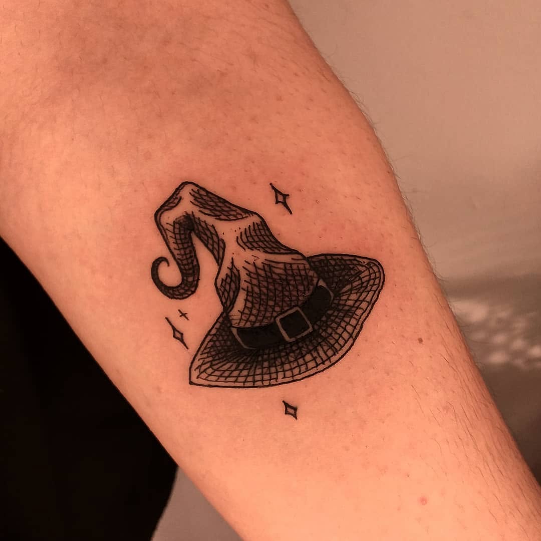 Charming witch hat tattoo with intricate details Tattoo on skin