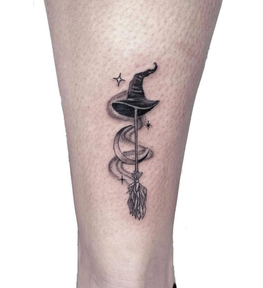 Elegant witch hat tattoo featuring celestial elements Tattoo on skin