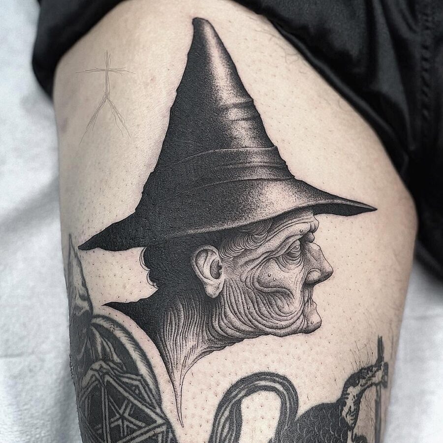 Intricate witch hat tattoo with elderly figure Tattoo on skin