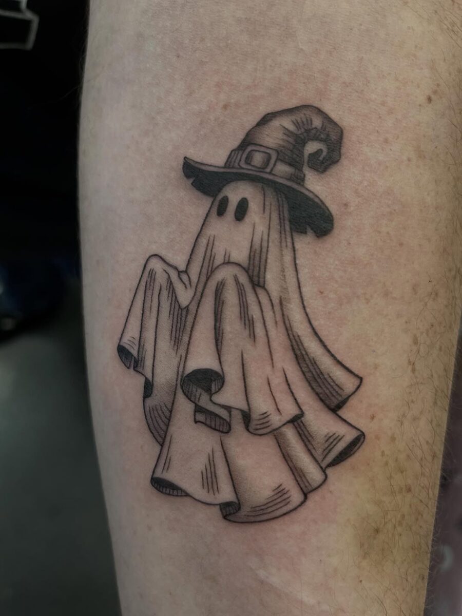 Whimsical ghost with a witch hat tattoo Tattoo on skin