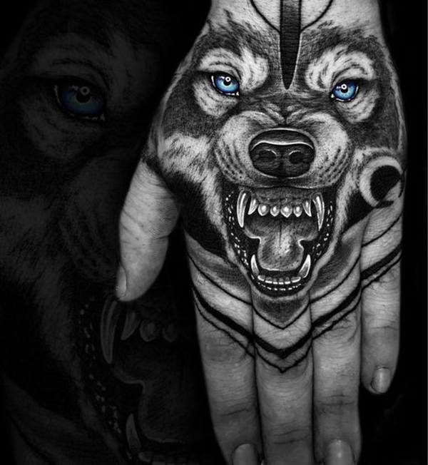 Blue-Eyed, Snarling Wolf Hand Tattoo Tattoo on skin