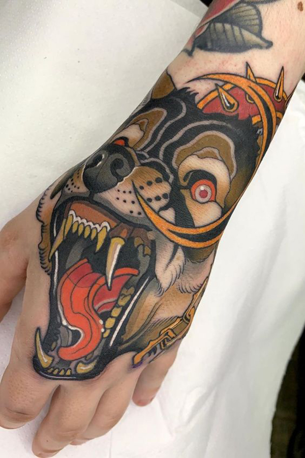 Colorful Snarling Wolf Hand Tattoo Tattoo on skin