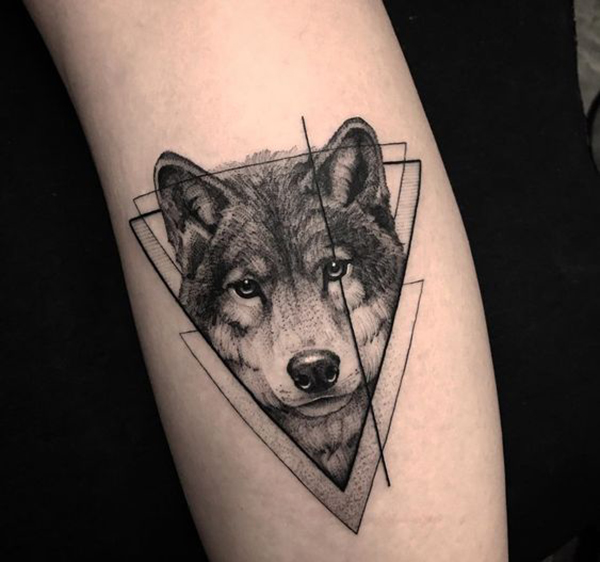 Realistic Wolf in Interlocking Triangles Tattoo on skin