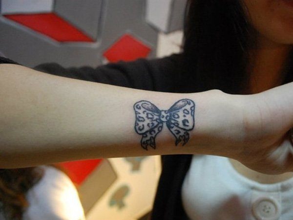Girlie Wrist Bow and Arrow Tattoos on the arm of a Woman Tattoo on skin